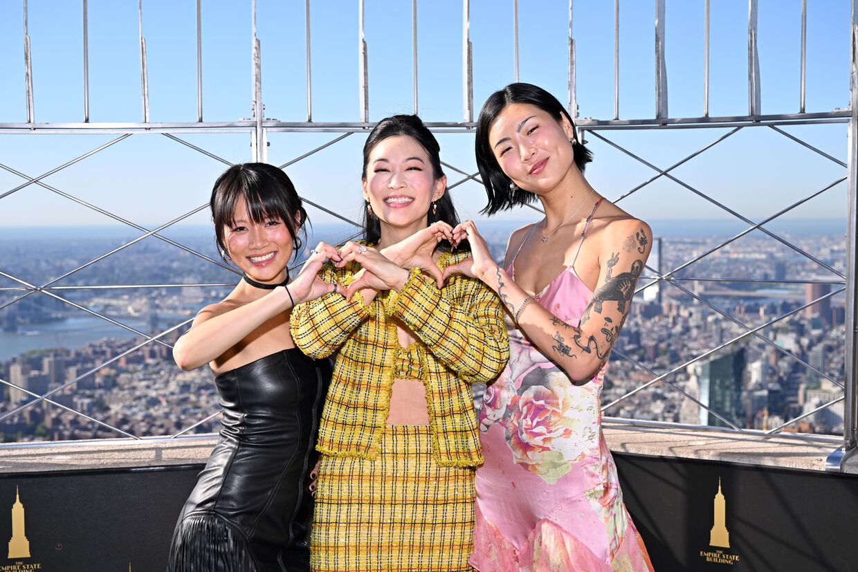 Arden Cho, May Hong, and REI AMI on the 86th Floor Observatory