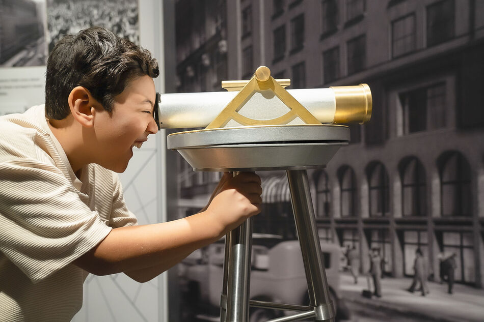 Child exploring the Empire State Building museum exhibit