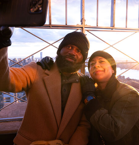 People taking a selfie with the view on the 86th Floor at the Empire State Building Observatry
