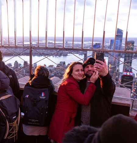 Guests taking a selfie on the 86th Floor Observation Deck at the Empire State Building Observatory.