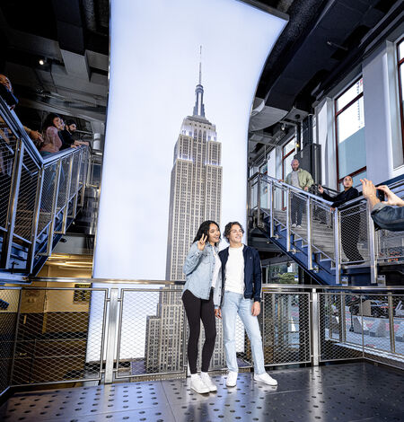 People taking photos at the grand staircase at the Empire State Building Observatory museum experience
