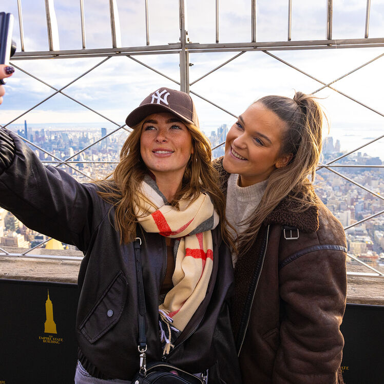 Two women on the 86th Floor Observation deck taking a selfie with the view at the EBSO